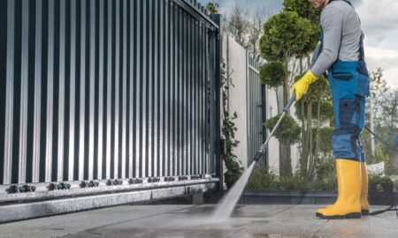 Man power washing a walkway