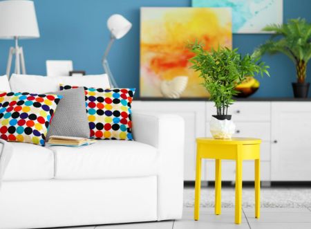 White chair with colorful pillows